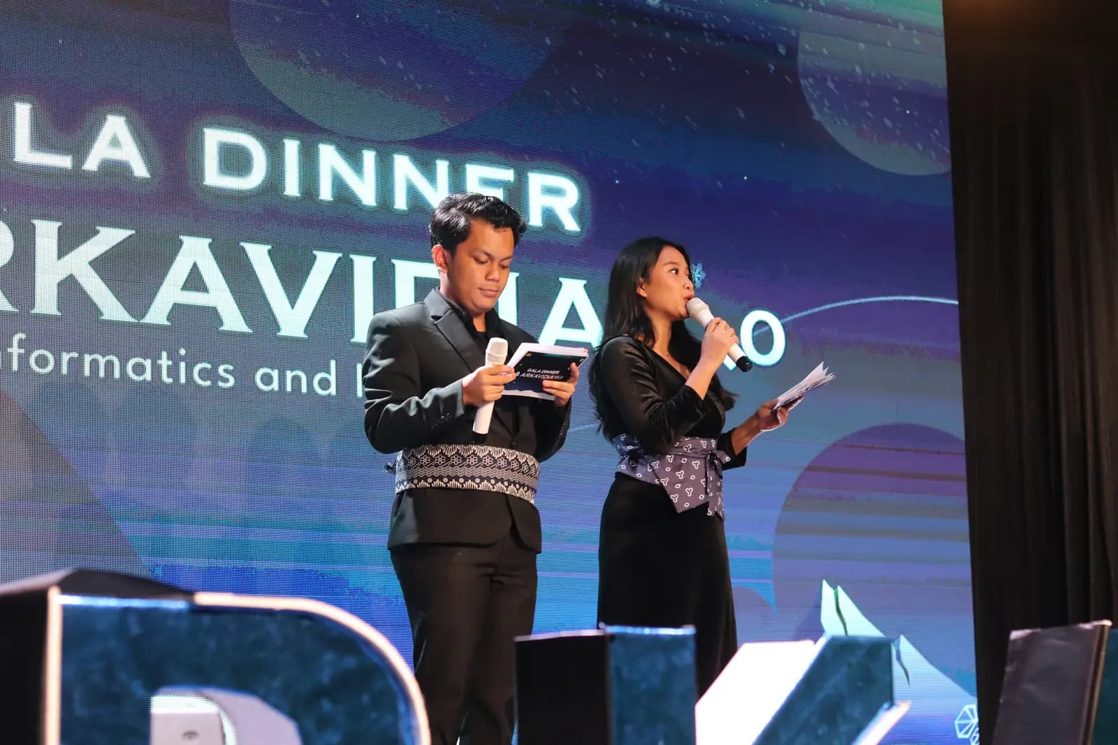 Hosts on stage at the Arkavidia gala dinner
